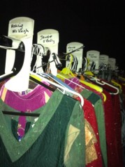 array of female costumes are all placed in order per act